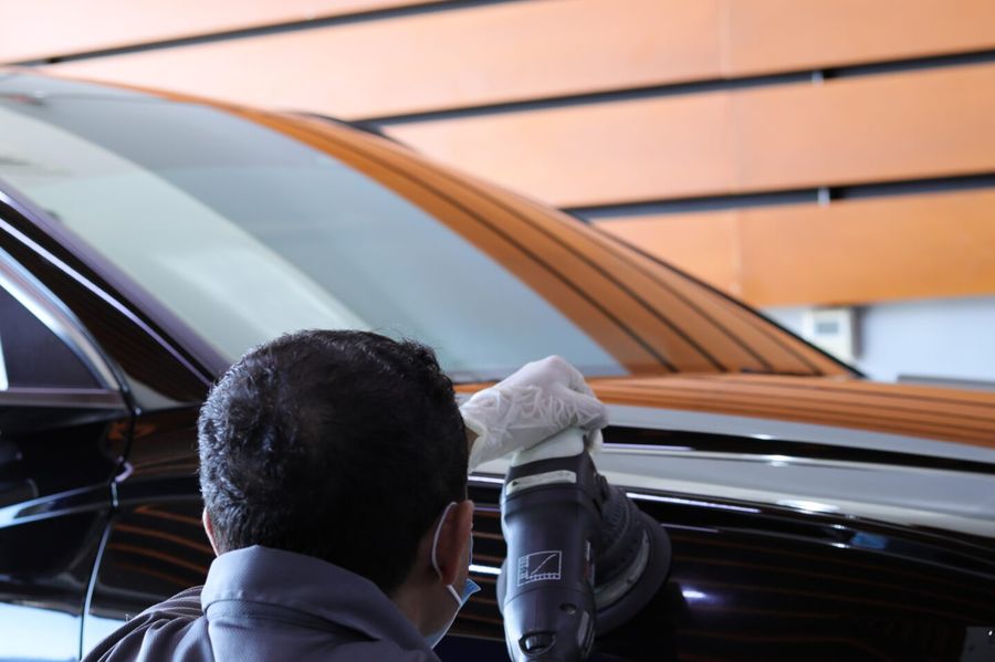 Ceramic coating being polished onto a car bonnet